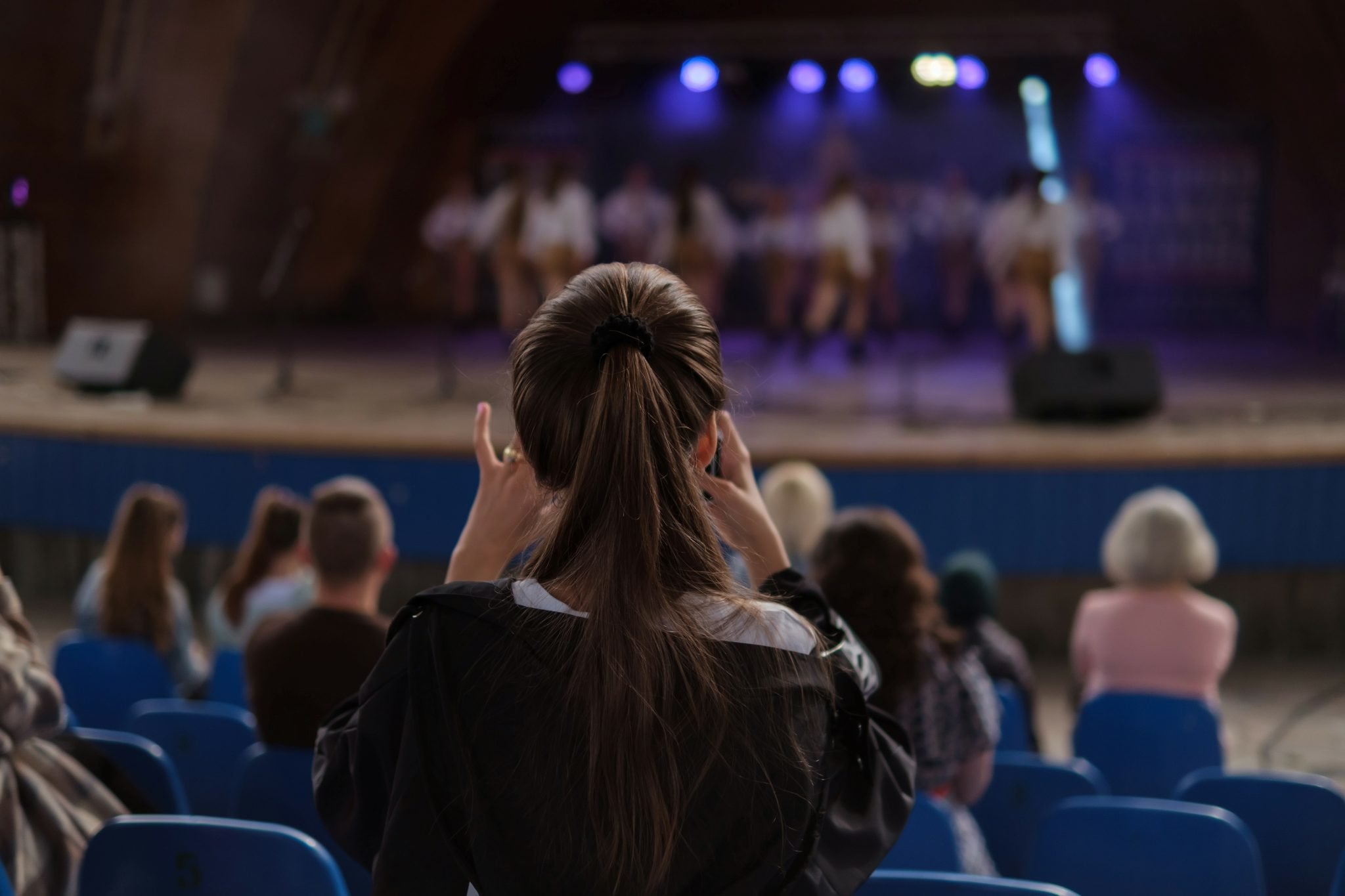 Girl recording stage performance