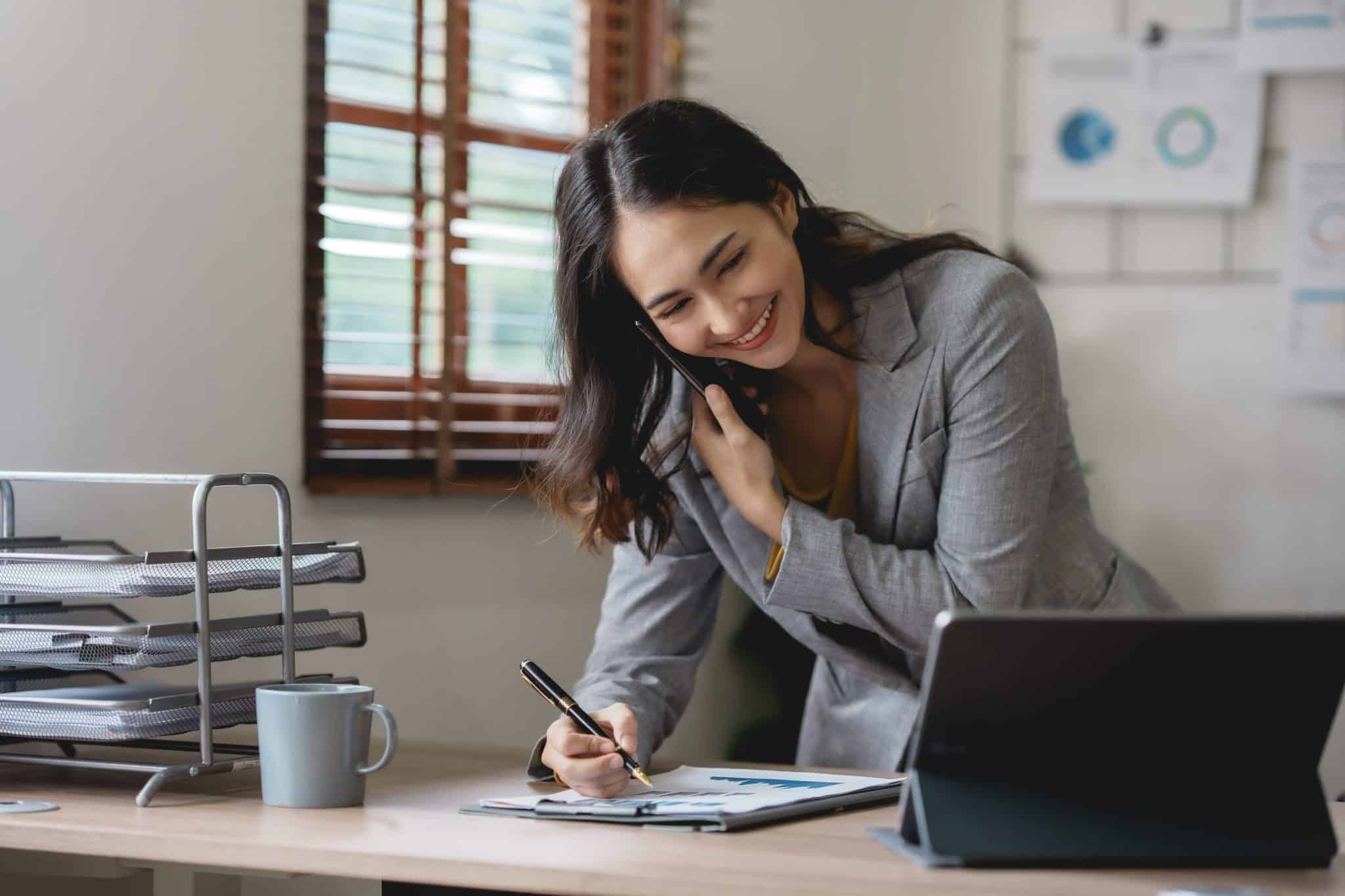 Real estate agent, talking on the phone with a Suburban Jungle client.