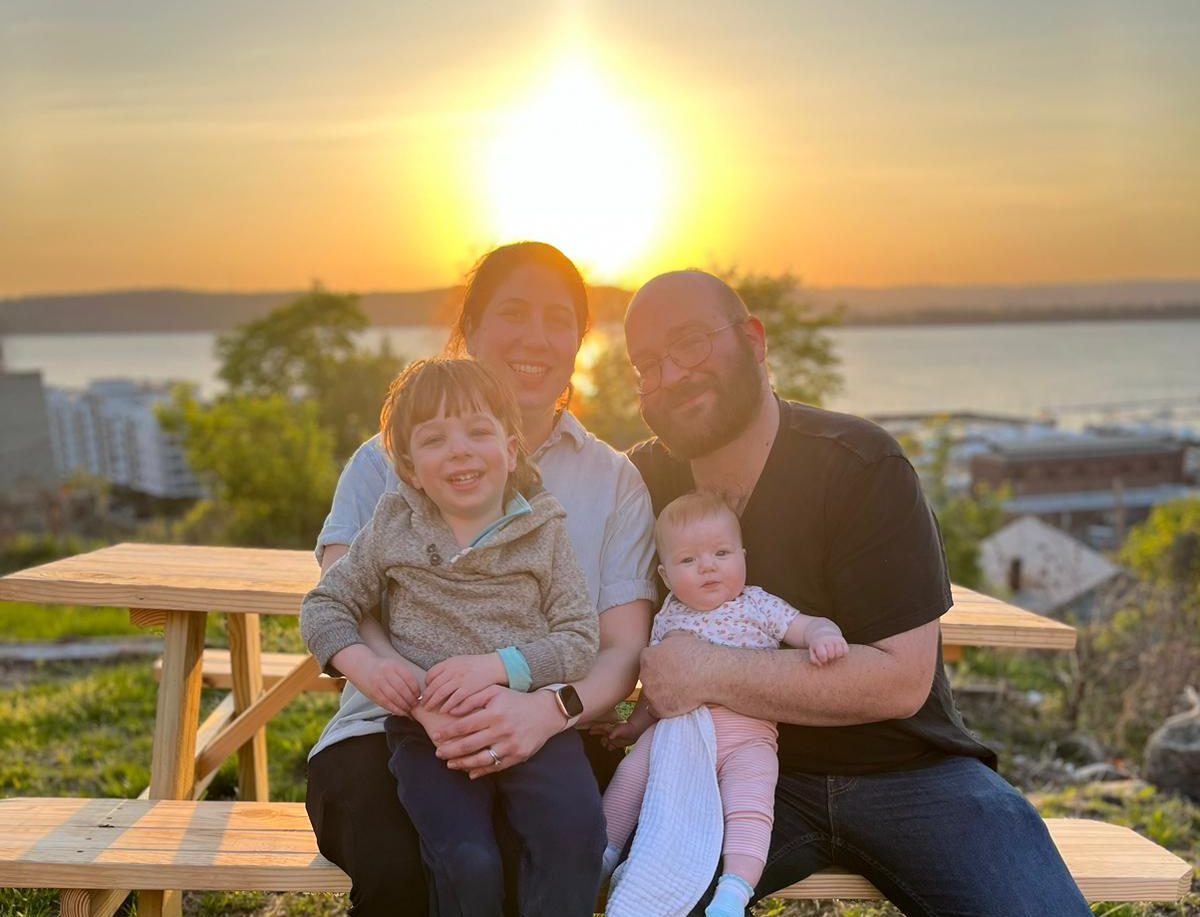 The Young family with scenic views of the Hudson River behind Riverworks.