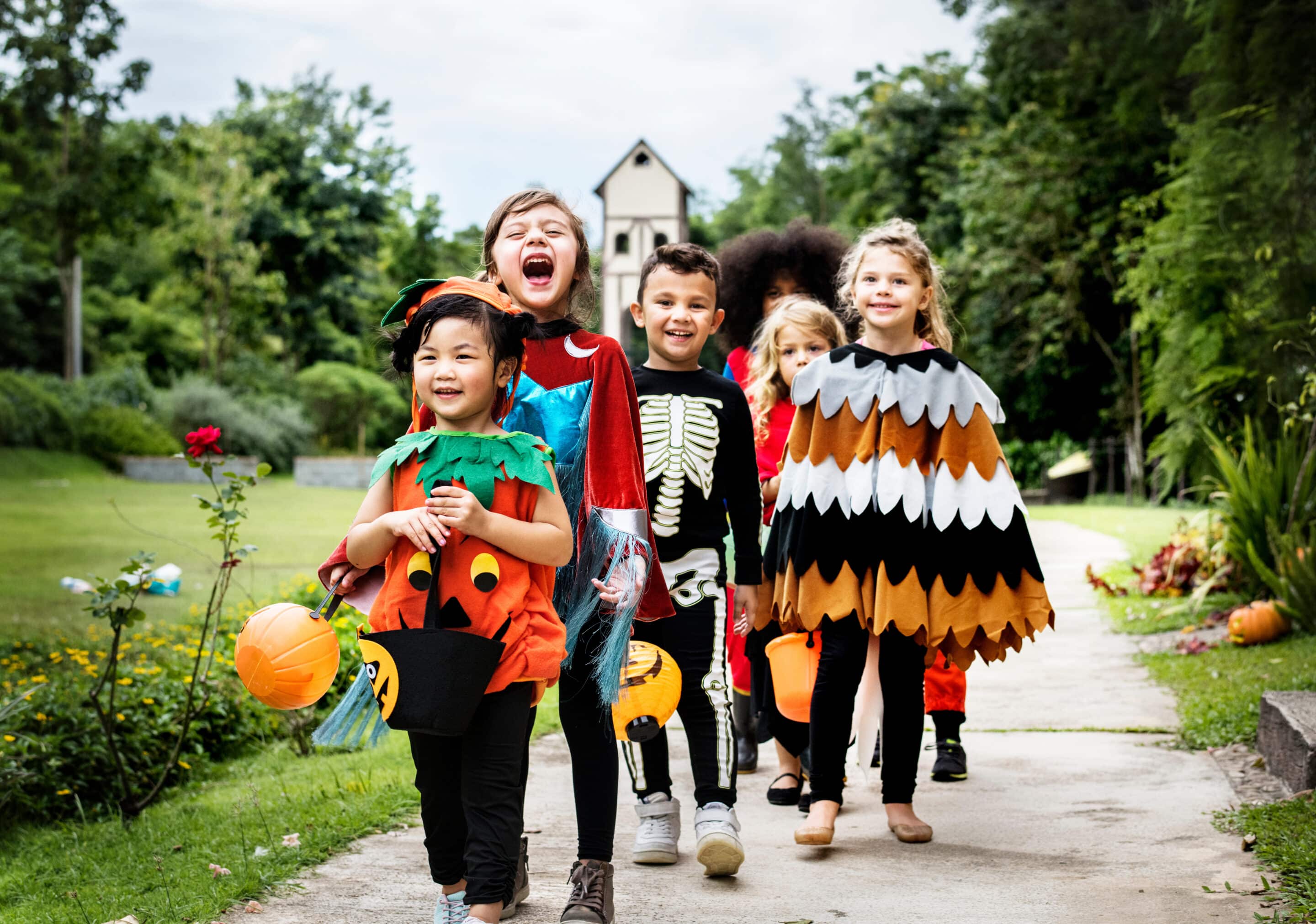 Family-Friendly Fall Festivals in Westchester County Children in Halloween costumes walking together outdoors during a fall festival in Westchester County.