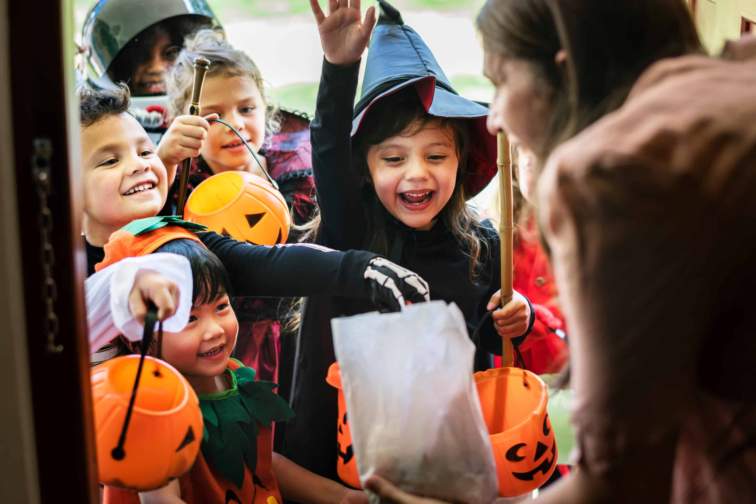 Halloween towns near the NYC suburbs Group of children in halloween costumes trick or treating