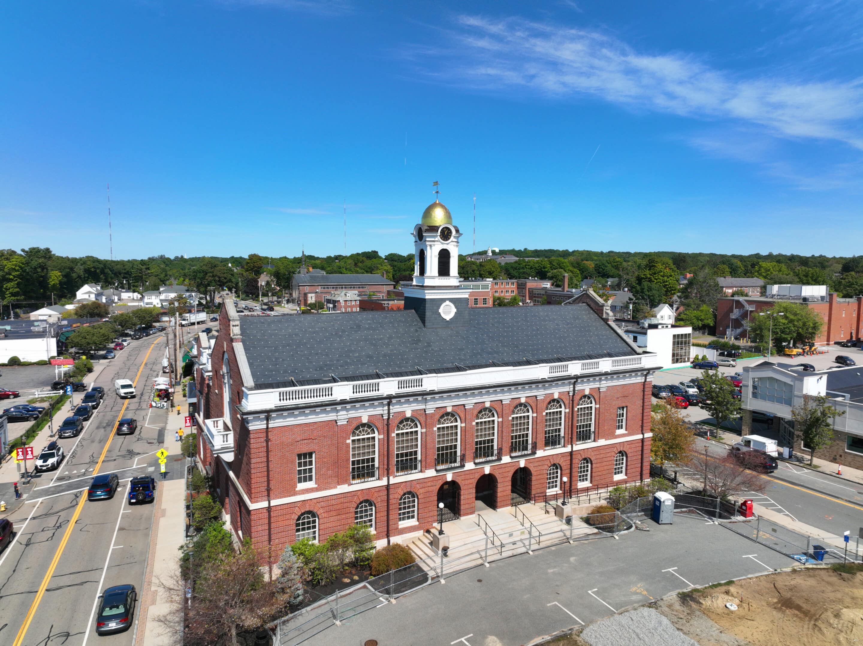 Aerial view of Needham Town Hall in Needham, Massachusetts, on a clear sunny day