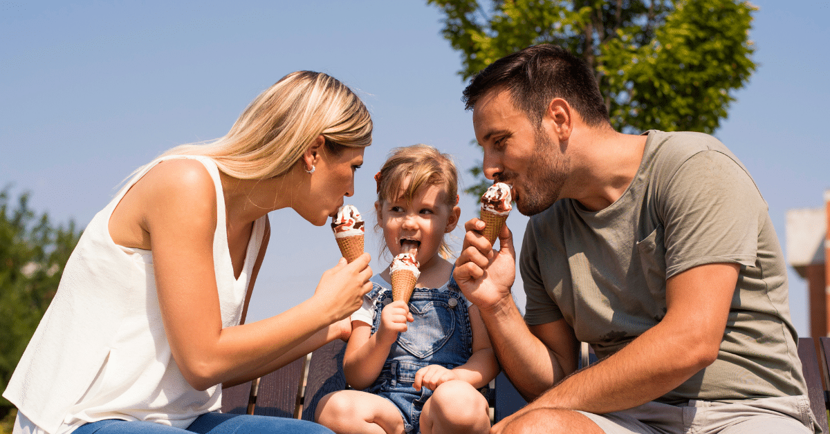 Family Enjoying Ice Cream in the Suburbs Family enjoying ice cream cones together outdoors on a sunny summer day in the suburbs