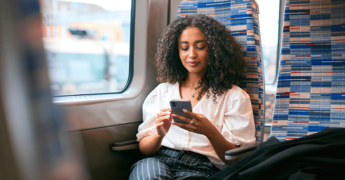 Commuting from Long Island to NYC by Train Woman using her phone while commuting by train from Long Island to New York City
