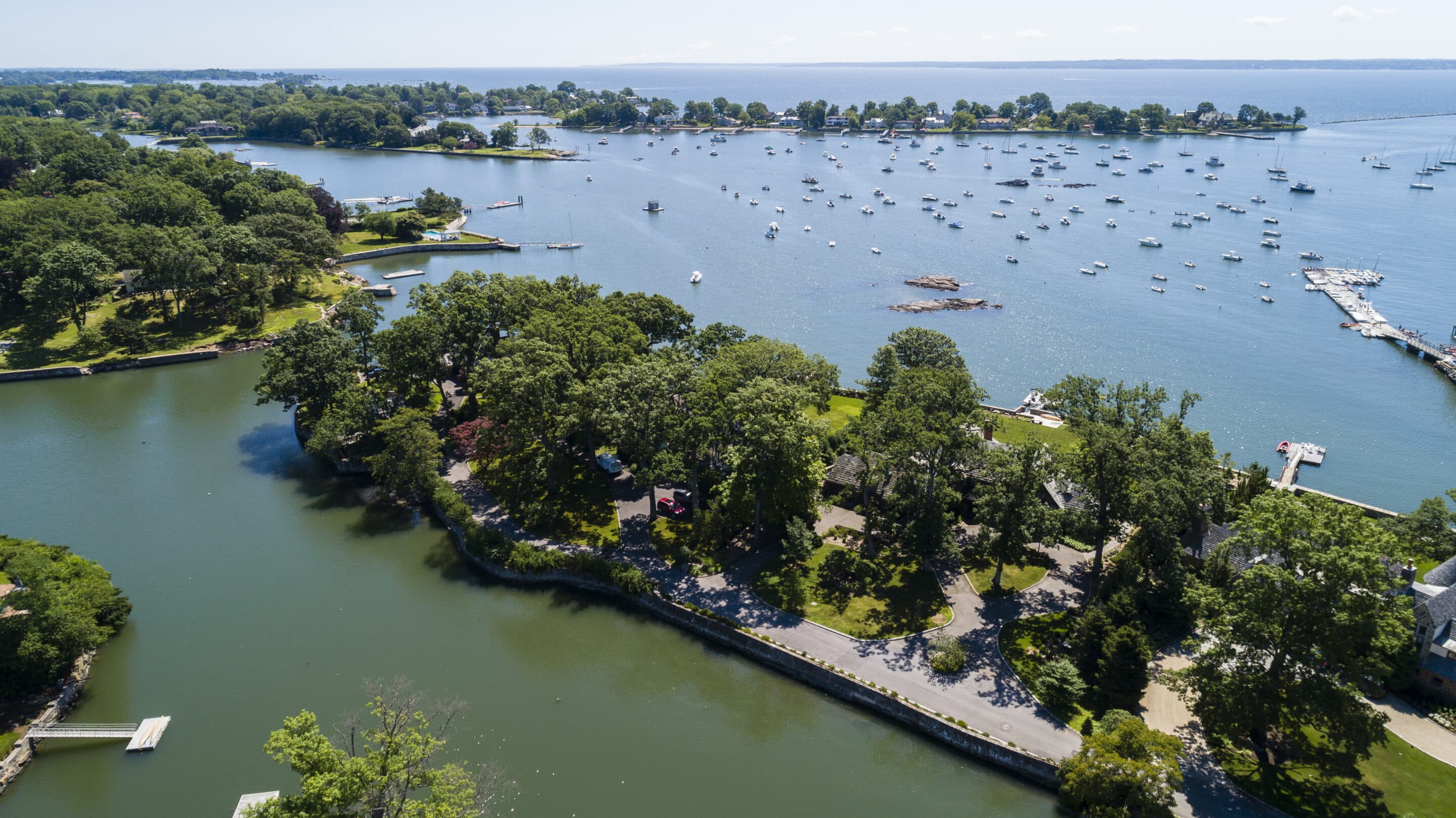 Larchmont Harbor Waterfront in Summer Aerial view of Larchmont Harbor with boats, waterfront homes, and the Long Island Sound on a summer day.