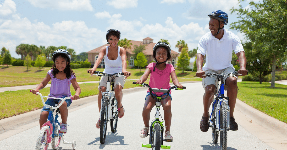 Choosing the Right Suburb Family riding bicycles together through a suburban neighborhood
