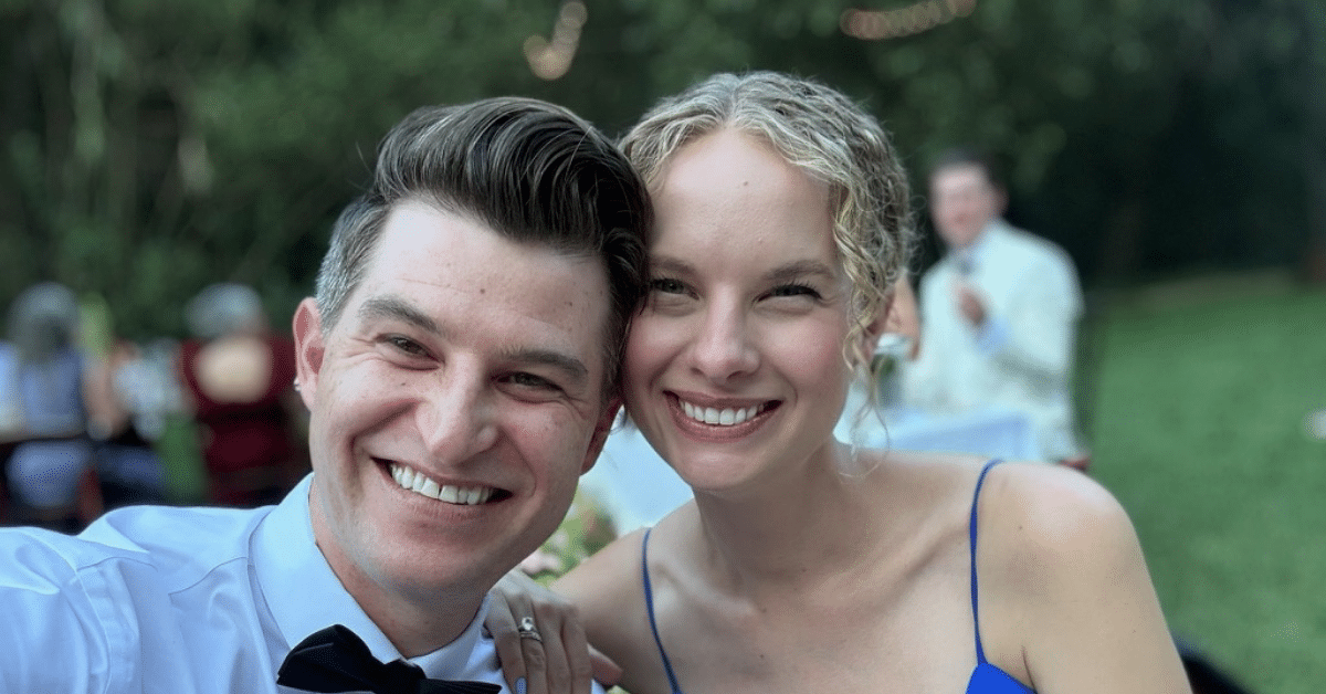 Kelsey and Dean – Suburban Jungle Client Story Kelsey and Dean smiling together outdoors before sharing their family's move from Riverdale to Pleasantville, Westchester.